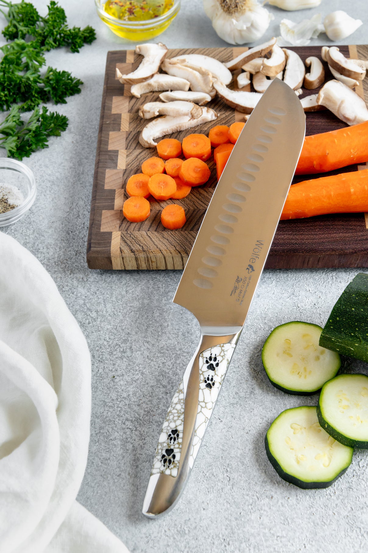 Chef's knife with decorative handle on a cutting board with vegetables