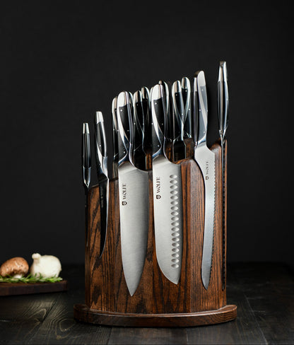 Set of knives in a wooden block on a dark background