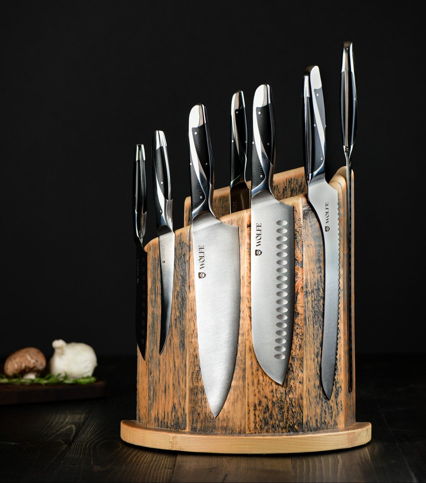 Set of knives in a wooden block on a dark background