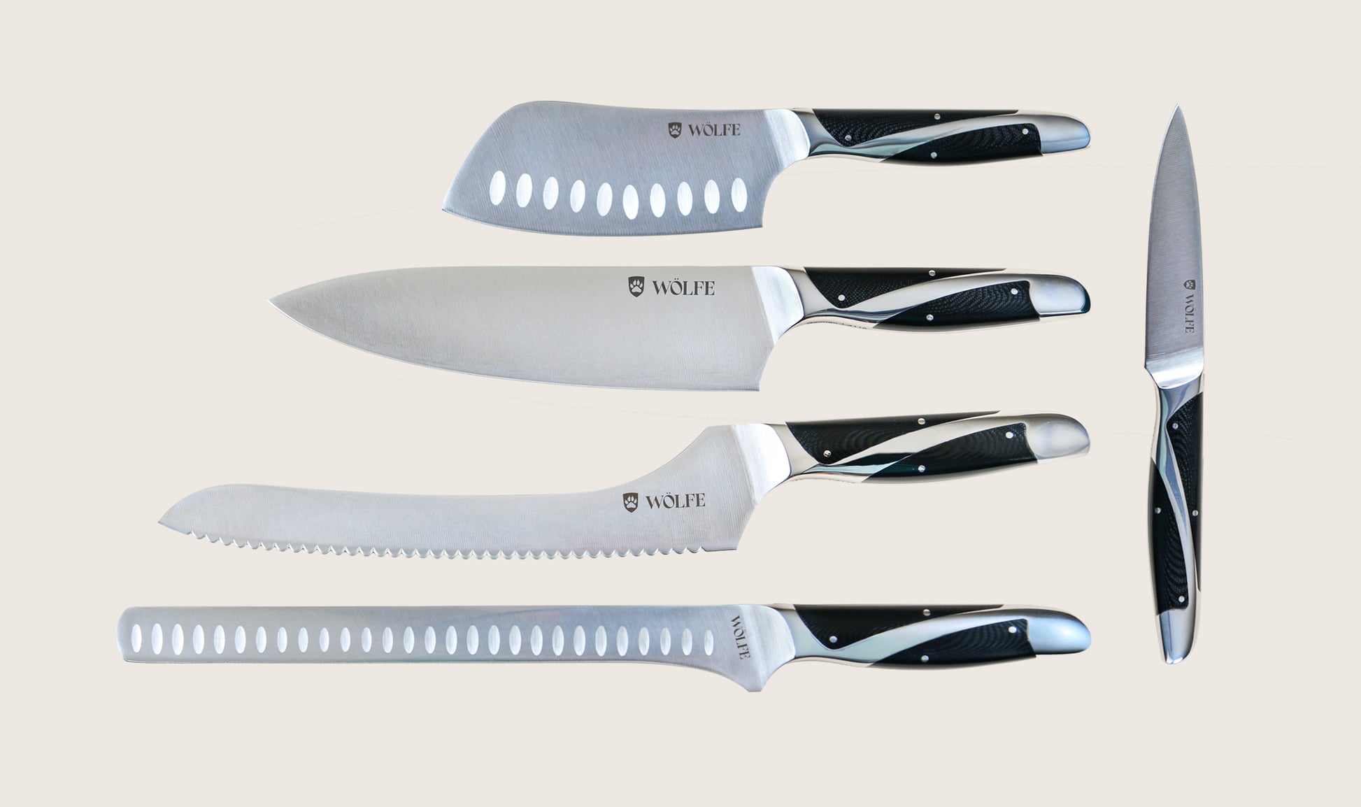 Set of knives with black handles on a beige background