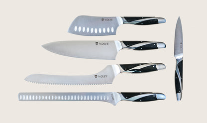 Set of knives with black handles on a beige background