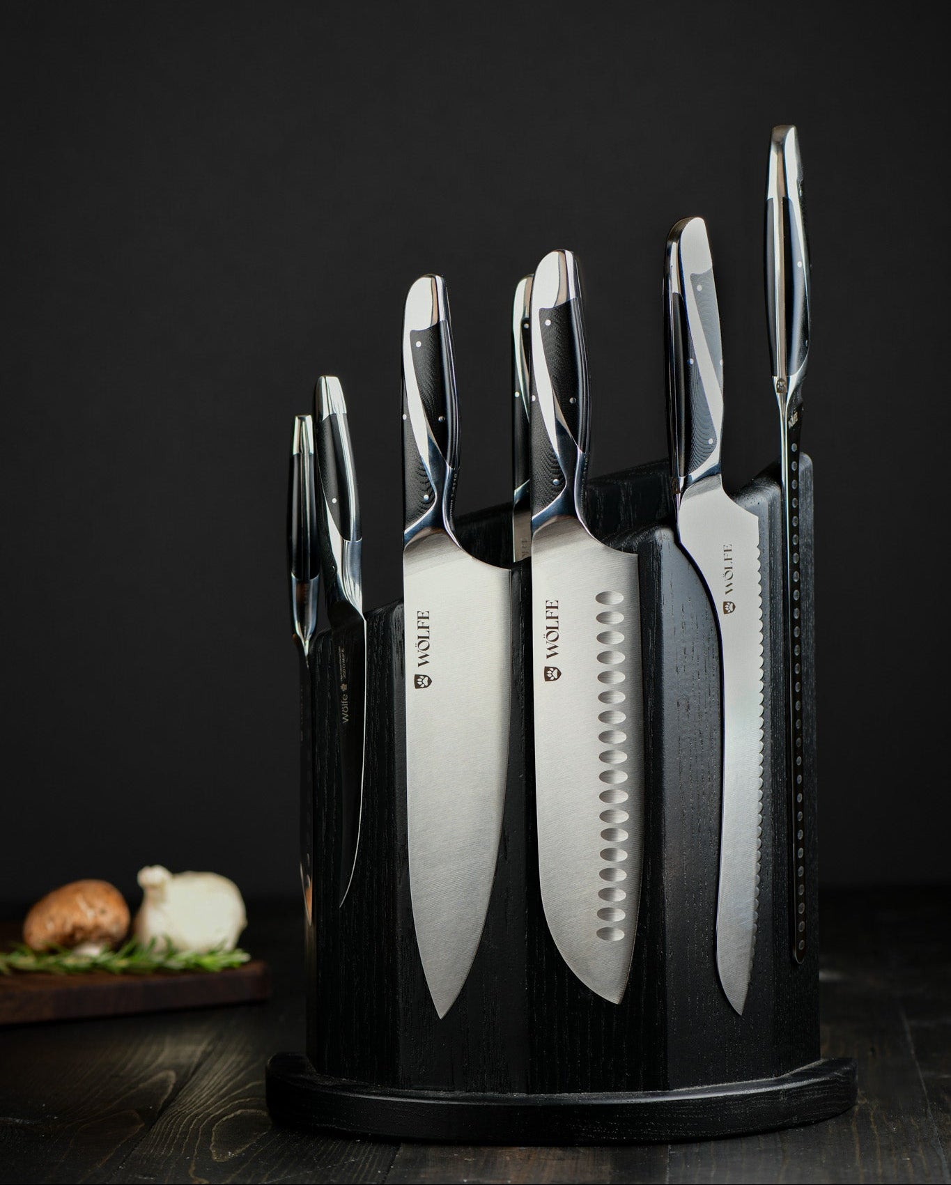 Set of knives in a black holder on a dark background